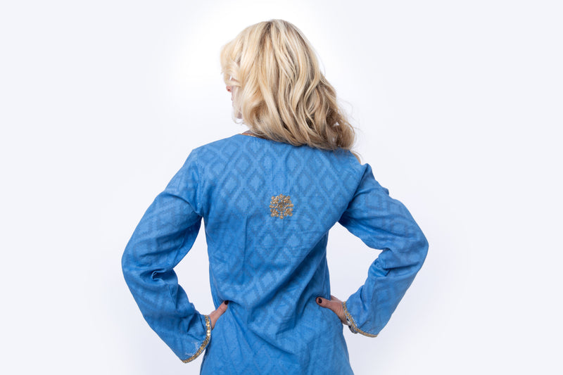 Hand woven blue tunic with intricate gold embroidery detail on sleeves, around the neck and on the back of the tunic. 