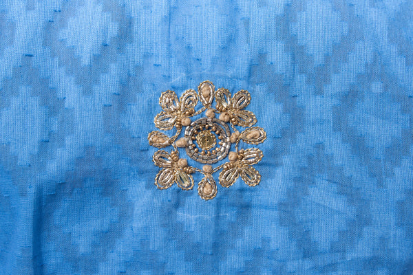 Hand woven blue cotton tunic with intricate gold embroidery detail on sleeves, around the neck and on the back of the tunic. 