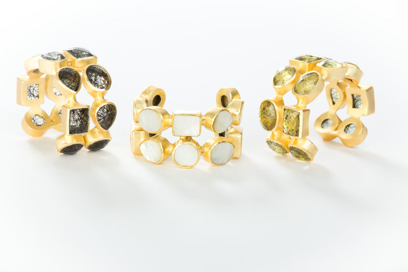 Two rows of natural gold rutilated quartz set in brass and 18k electro-gold plated. Adjusts to fit most wrists.
