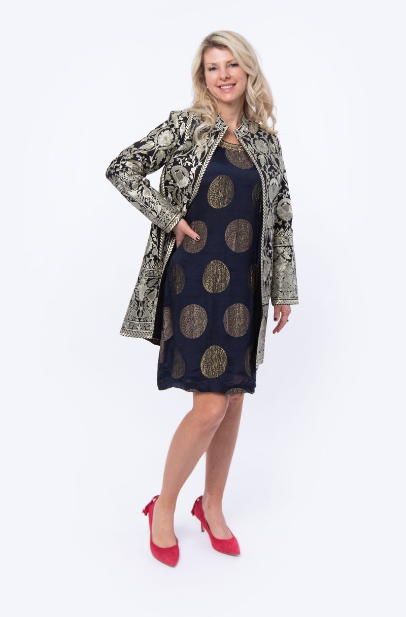 The Kota dress is a sleeveless brocade dress in navy with gold embroidery around the neck and a motif at the back of the dress. This dress is similar to a sheath dress and can be worn year round. 