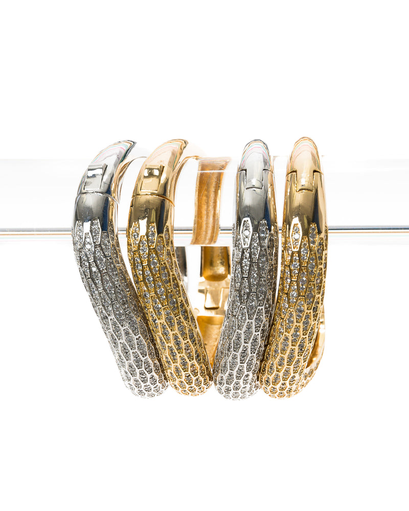 Simple, classic, and beautiful in a stack or alone, the Chloe Cuff is the sparkle accent that complements any outfit. This elegant 18k gold electroplated cuff laden with Swarovski crystals features a hinge in the middle. The hinge mechanism makes it easy to get on and off, and comfortable to wear. This handmade cuff goes well with casual, professional, and formal wear; its classic simplicity lends it to any occasion! 