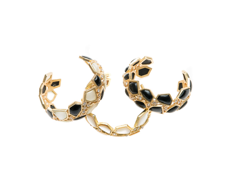 Asymmetrical natural black agate stone is set in gold plated metal around Swarovski crystal to create this cuff that is easy to wear and fits most wrists. 