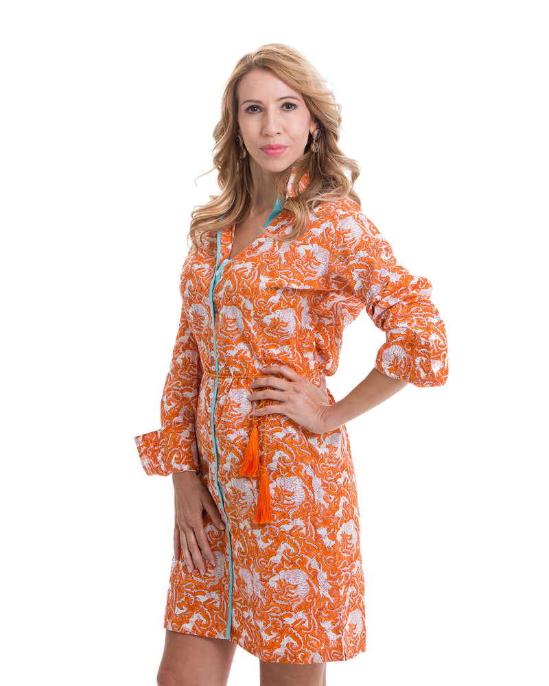 Hand block printed cotton dress in orange with turquoise trim. Embroidery detail in the back of the shirt.