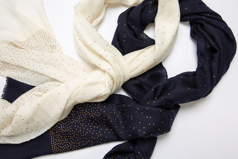 The Ethereal shawl is a hand woven light weight cashmere shawl that is embellished with gold Swarovski crystals over the entire length of the shawl. The shawl is sold in black or white. 