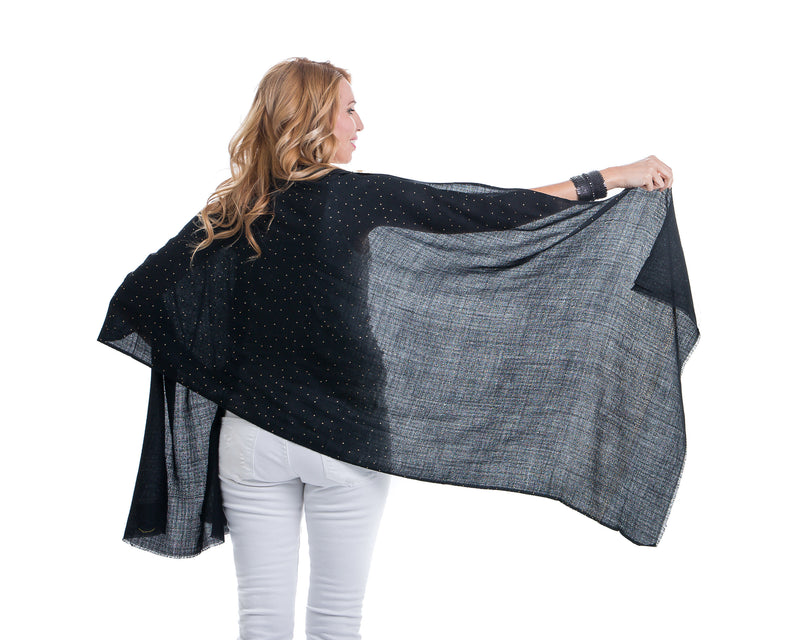 The Ethereal shawl is a hand woven light weight cashmere shawl that is embellished with gold Swarovski crystals over the entire length of the shawl. The shawl is sold in black or white. 