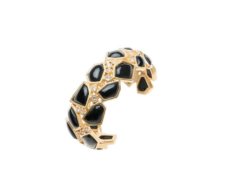 Asymmetrical natural black agate stone is set in gold plated metal around Swarovski crystal to create this cuff that is easy to wear and fits most wrists. 