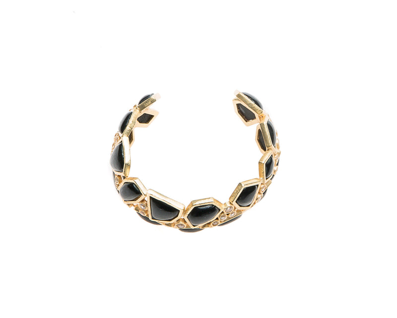 Asymmetrical natural black agate stone is set in gold plated metal around Swarovski crystal to create this cuff that is easy to wear and fits most wrists. 