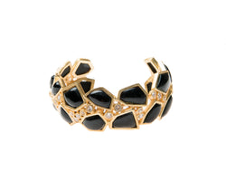 Asymmetrical natural black agate stone is set in gold plated metal around Swarovski crystal to create this cuff that is easy to wear and fits most wrists. 