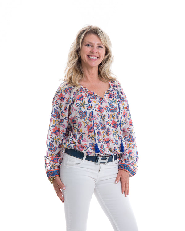 Floral block printed soft cotton full sleeve top with a navy tassel detail .