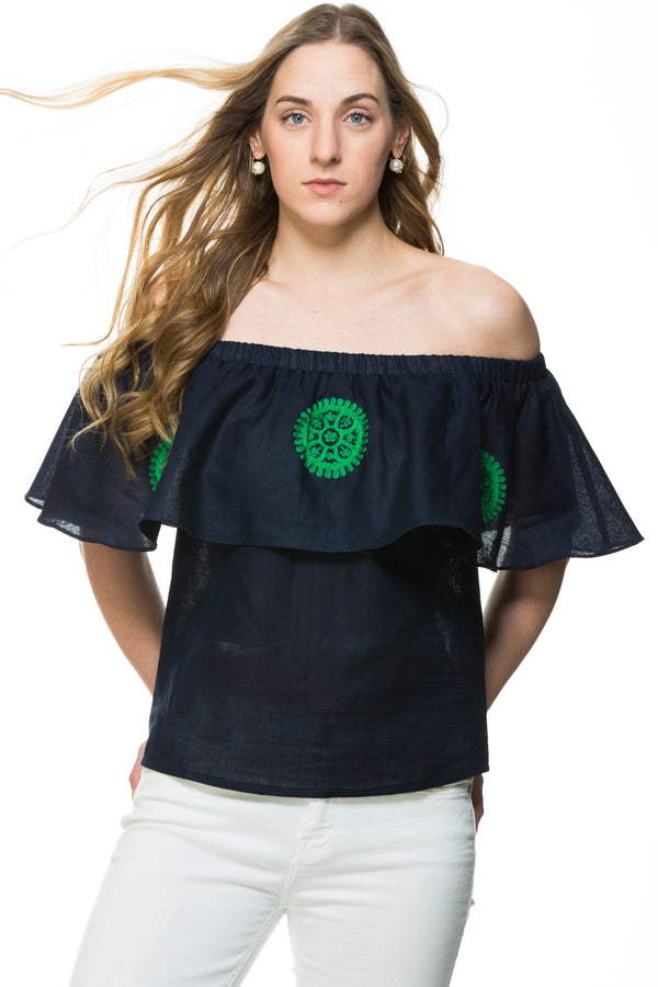 Navy Linen top with green embroidery detail. This top can be worn of the shoulders or as a scoop neck. It has a frill detail around the neckline.