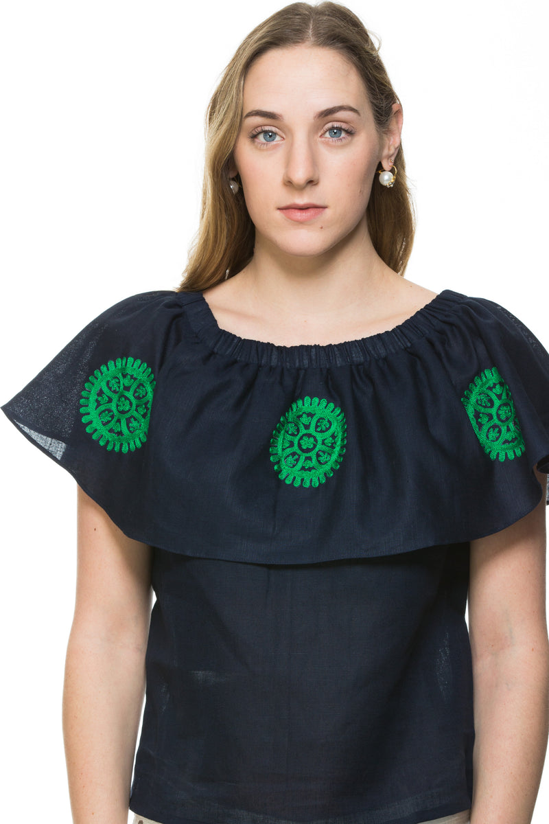 Navy Linen top with green embroidery detail. This top can be worn of the shoulders or as a scoop neck. It has a frill detail around the neckline.