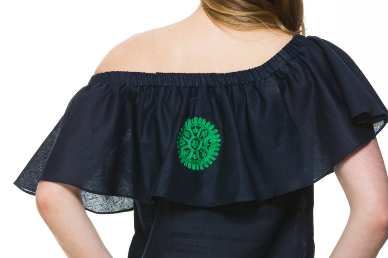 Navy Linen top with green embroidery detail. This top can be worn of the shoulders or as a scoop neck. It has a frill detail around the neckline.