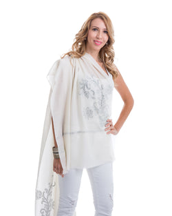 The image showcases the Yatra Halcyon Shawl that is offered in black and white. The cashmere shawl is decorated with large floral motifs at the two ends of the shawl with Swaravoski crystals in varied shapes and sizes. 