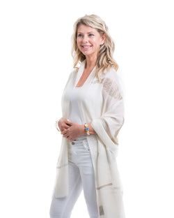 The Elixir cashmere shawl is embellished with Swarovski crystals. The crystals form a  leaf pattern all over the shawl. Two rows of crystals form a border along the two ends of the width. 