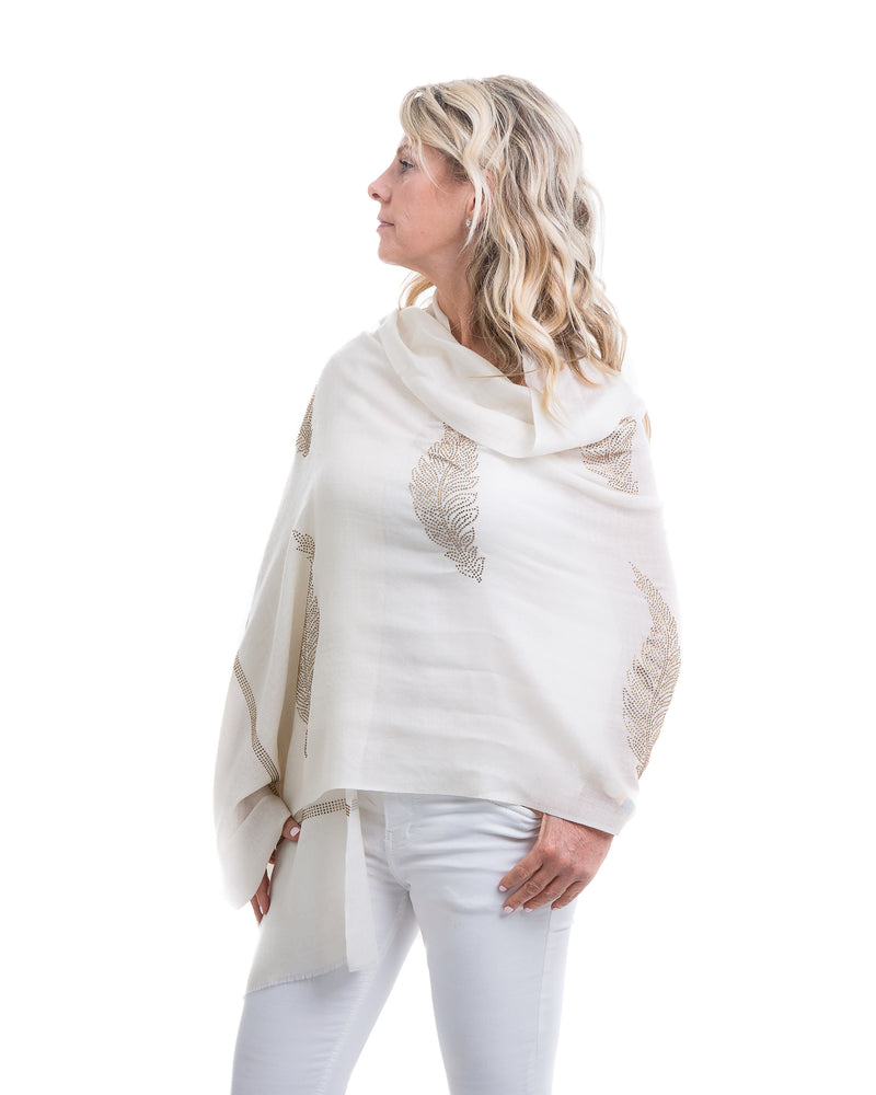 The Elixir cashmere shawl is embellished with Swarovski crystals. The crystals form a  leaf pattern all over the shawl. Two rows of crystals form a border along the two ends of the width. 