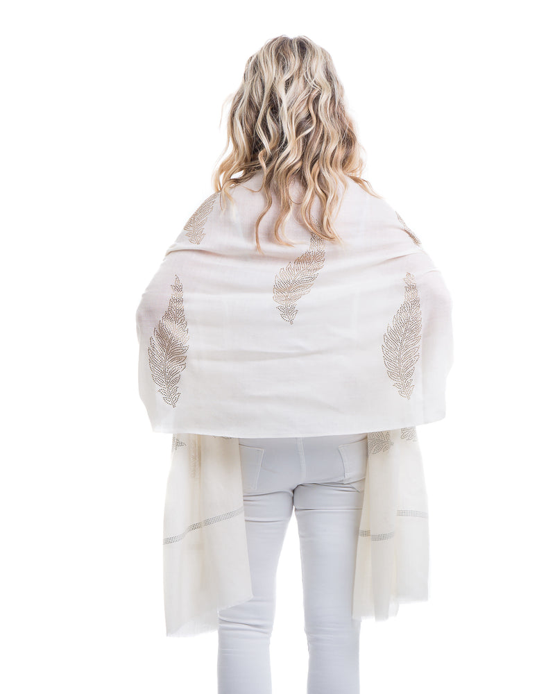 The Elixir cashmere shawl is embellished with Swarovski crystals. The crystals form a  leaf pattern all over the shawl. Two rows of crystals form a border along the two ends of the width. 