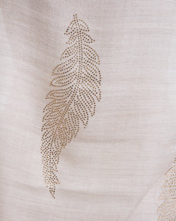 The Elixir cashmere shawl is embellished with Swarovski crystals. The crystals form a  leaf pattern all over the shawl. Two rows of crystals form a border along the two ends of the width. 