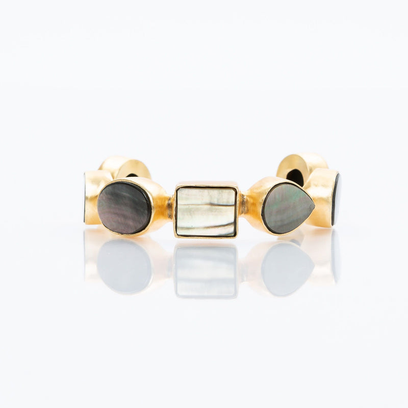 Natural slate mother-of-pearl stones set in brass and 18k electro-gold plated. Adjusts to fit most wrists.