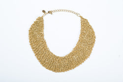 The Ella mesh necklace is hand crocheted and can be worn as a choler. It comes in 3 finishes, gold, white gold and black. 