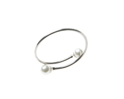Delicate cuff bangle  adorned with pearl on either end. This cuff is easy to wear and fits most wrists. Can be worn alone or staked with other pieces. 