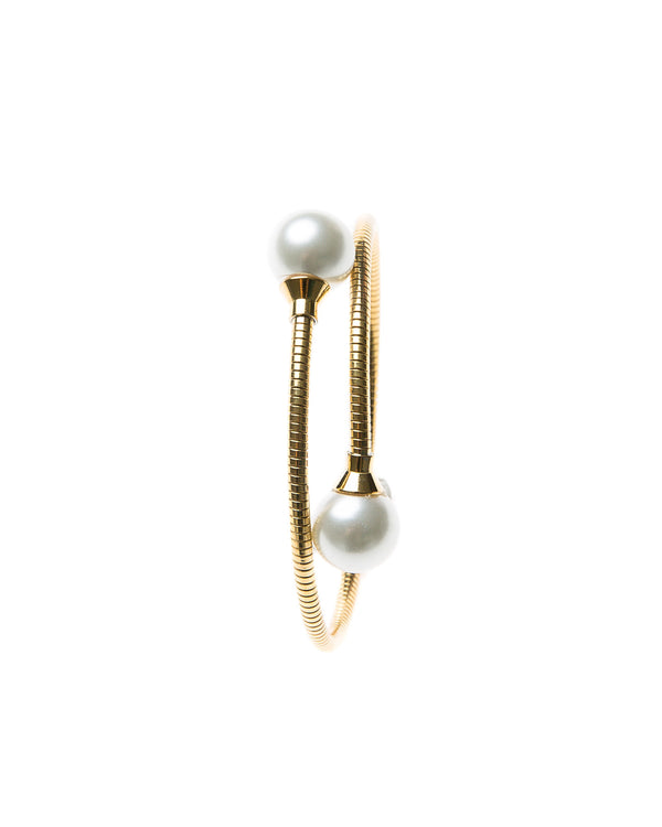 Delicate gold plated cuff bangle  adorned with pearl on either end. This cuff is easy to wear and fits most wrists. Can be worn alone or staked with other pieces. 