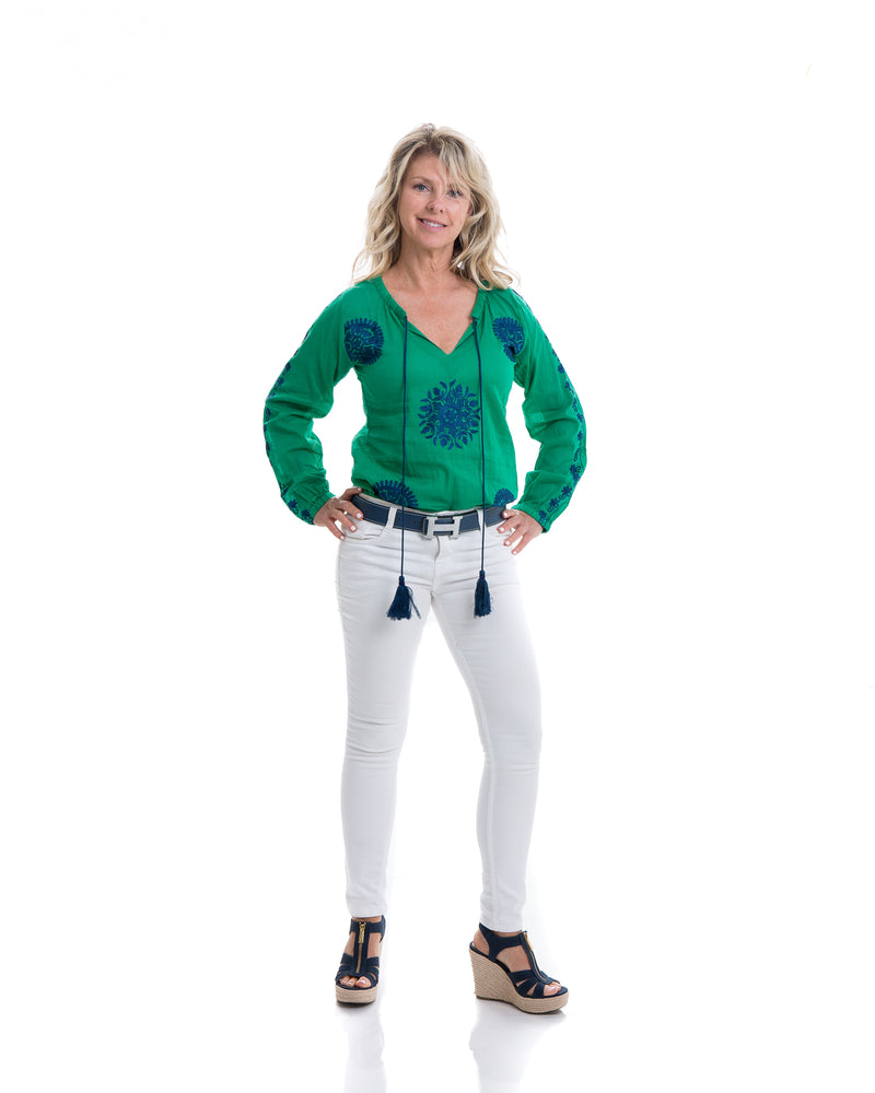 Light weight cotton tunic with extensive embroidery along the length of sleeve, front and back of the tunic. The tunic has a tassel detail that can be tied or left open. Offered in various colors.