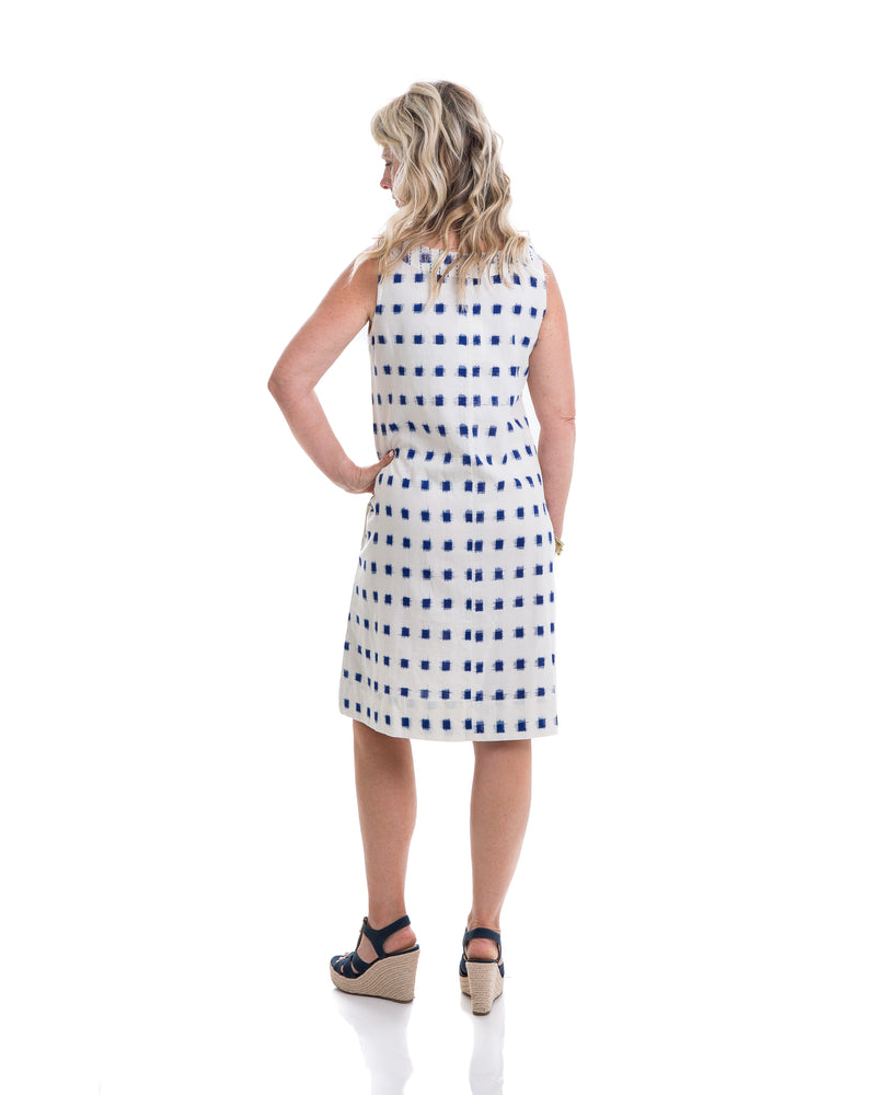 The Ikat dress is a sleeveless block printed dress that comes with a belt to define the waist. The dress is white with navy blue ikat block printing. The pockets add a nice finishing touch to the dress. 