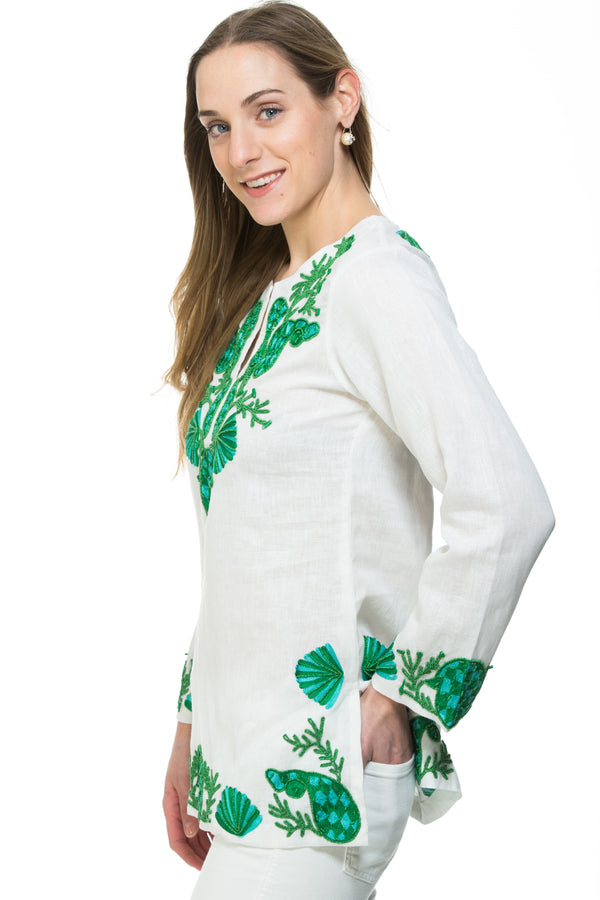 White linen tunic with substantial hand embroidery with faux coral detail. The embroidery is in either green, red or blue. Embroidery detail in around the neck, sleeves and at the bottom of the tunic. 