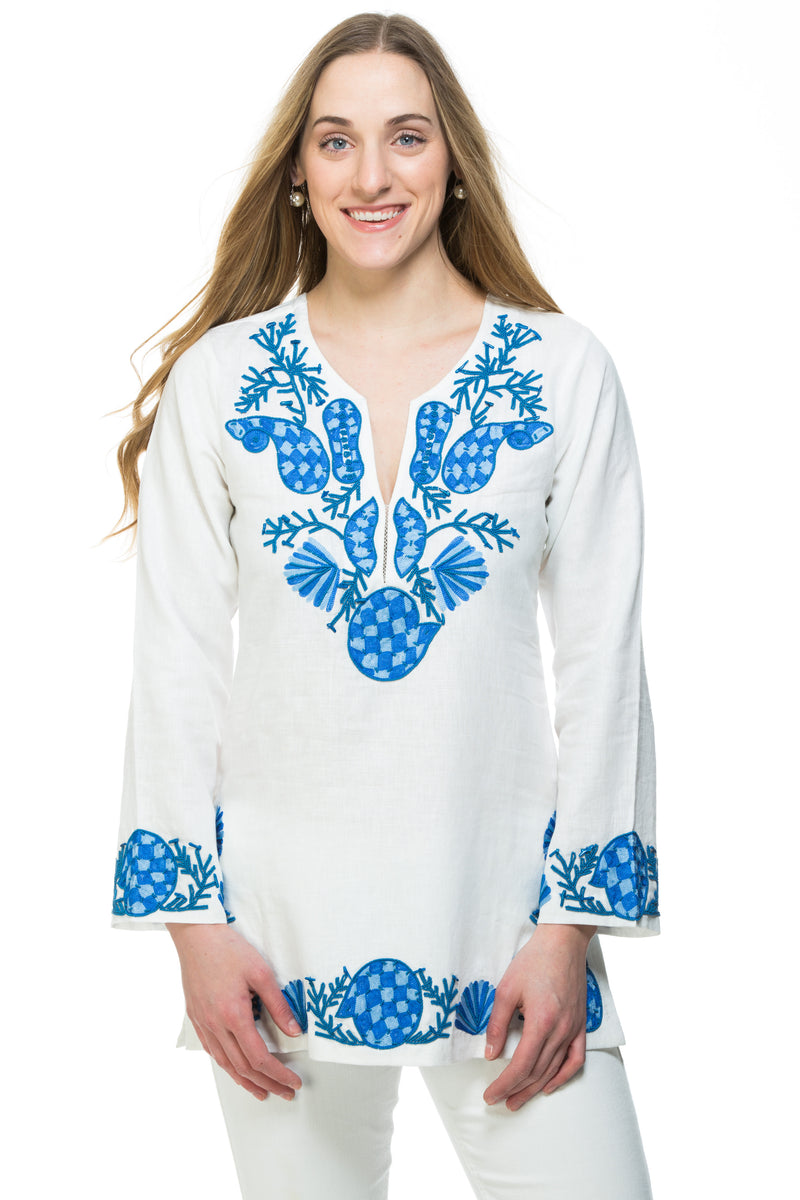 White linen tunic with substantial hand embroidery with faux coral detail. The embroidery is in either green, red or blue. Embroidery detail in around the neck, sleeves and at the bottom of the tunic. 