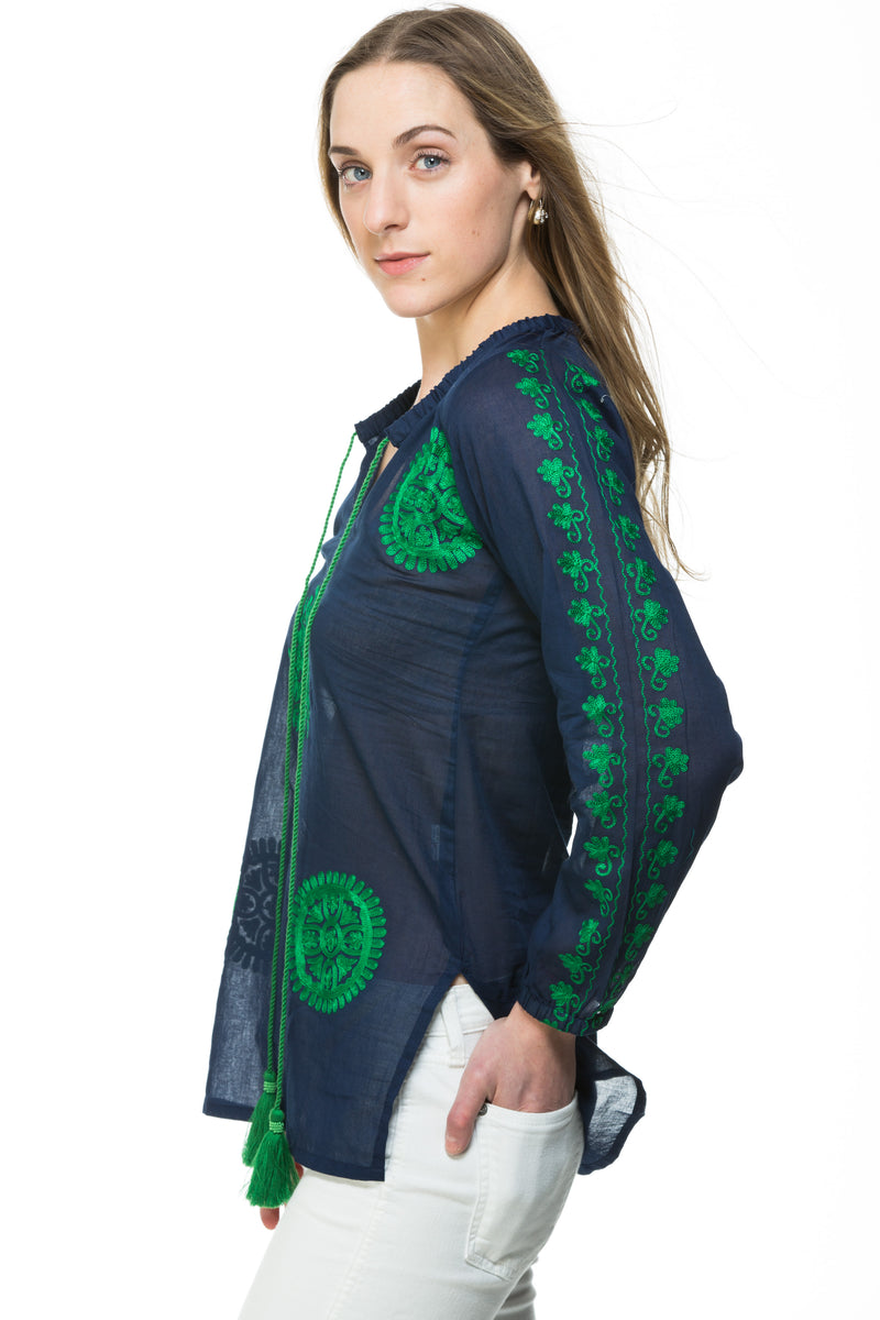 Light weight cotton tunic with extensive embroidery along the length of sleeve, front and back of the tunic. The tunic has a tassel detail that can be tied or left open. Offered in various colors.
