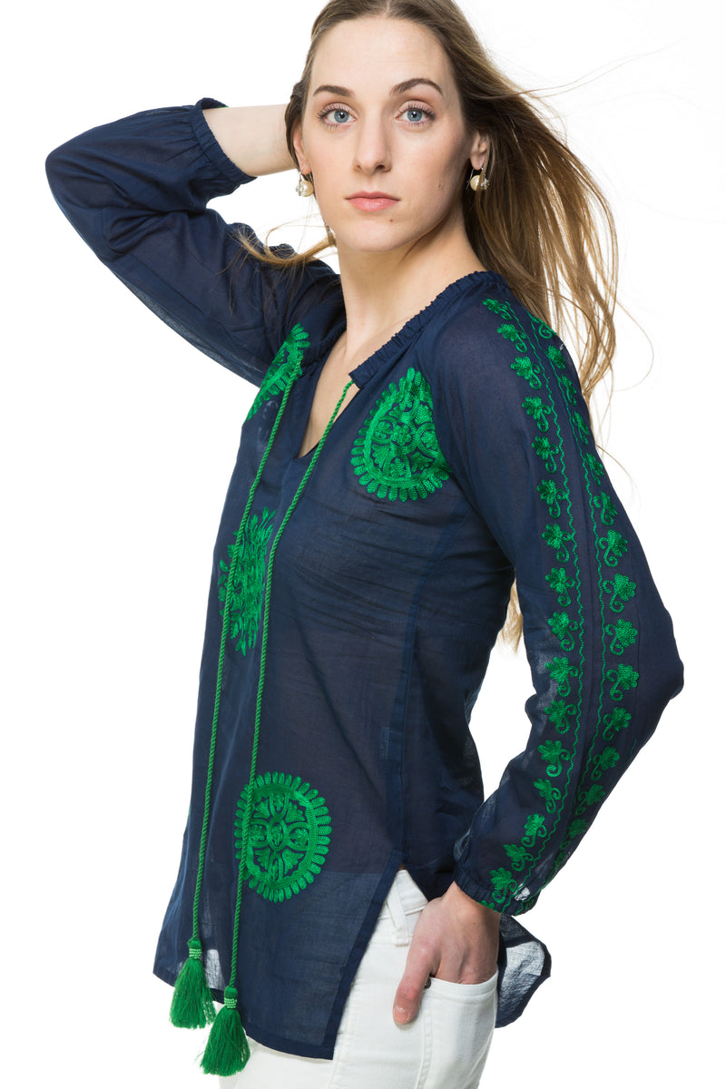 Light weight cotton tunic with extensive embroidery along the length of sleeve, front and back of the tunic. The tunic has a tassel detail that can be tied or left open. Offered in various colors.