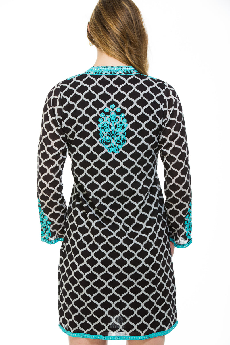 Hand screen printed organic cotton with window pane print and embroidery with  mirror work around the neck, sleeves and bottom of dress. Embroidered motif at the back of the dress. 