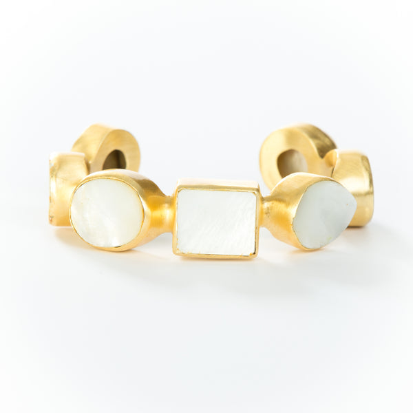 Natural white mother-of-pearl stones set in brass and 18k electro-gold plated. Adjusts to fit most wrists.