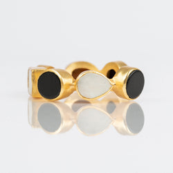 Natural black onyx and mother-of-pearl stones set in brass and 18k electro-gold plated. Adjusts to fit most wrists.