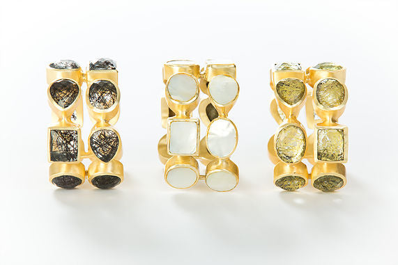 Two rows of natural gold rutilated quartz set in brass and 18k electro-gold plated. Adjusts to fit most wrists.