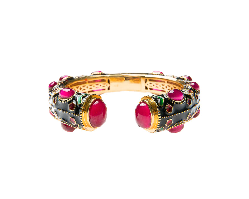 This is a special occasion cuff embellished with semi precious stones and enamel work. The enamel work is an ancient Indian art form. 